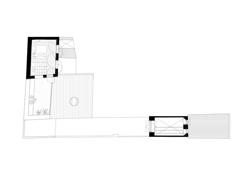 Floor plan drawing showing an L-shaped layout with outdoor deck, planted beds, and covered terrace