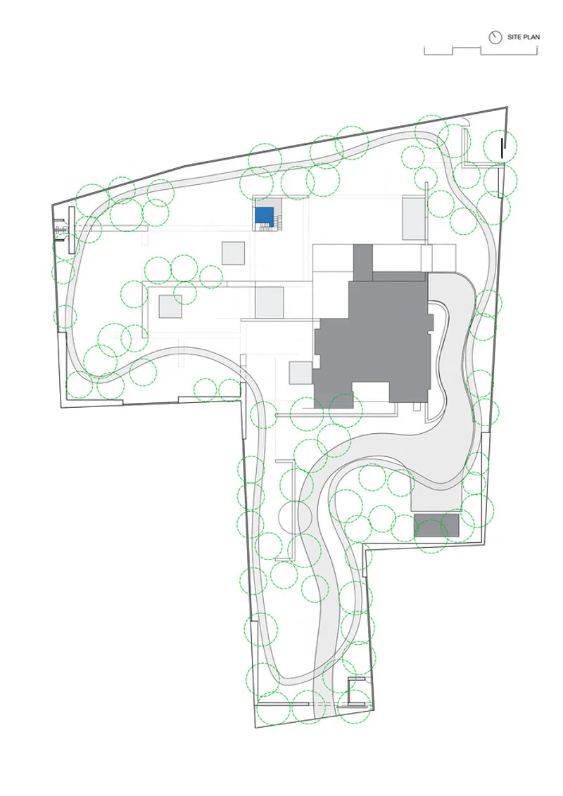 Site plan drawing showing building volumes in grey with landscaping circles and curving pathways