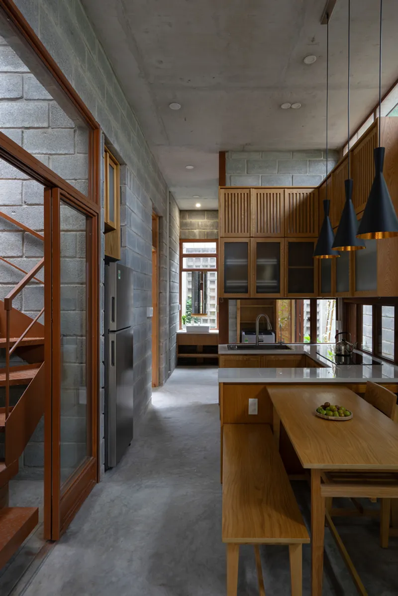 Open-plan kitchen and living area with concrete block walls and exposed ceiling