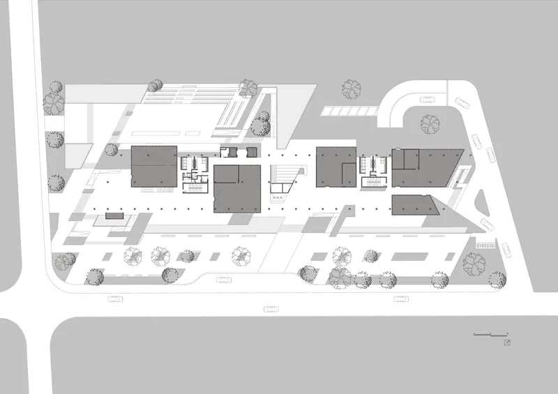 Site plan drawing showing building volumes, pathways, tree locations and parking areas across the property