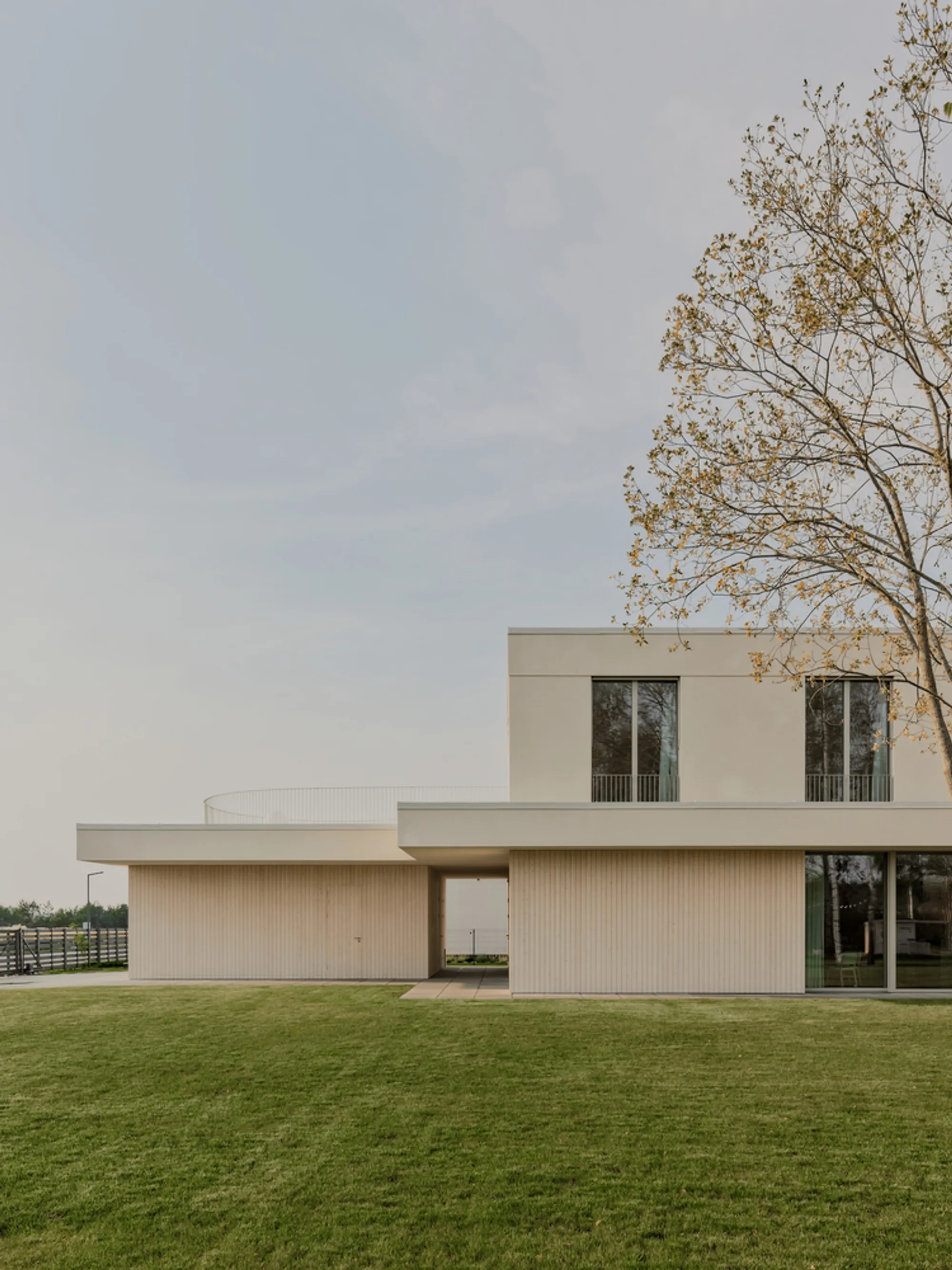 GAISS Wraps a Latvian Family Home in Lime Plaster and Timber for a Quiet Suburban Life