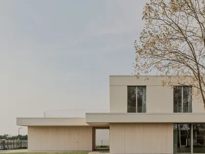 GAISS Wraps a Latvian Family Home in Lime Plaster and Timber for a Quiet Suburban Life