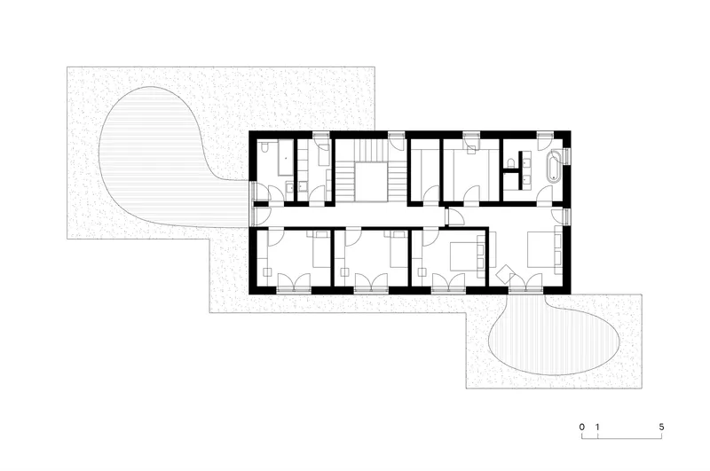 Upper floor plan drawing showing bedroom wing with curved outdoor terraces at each end