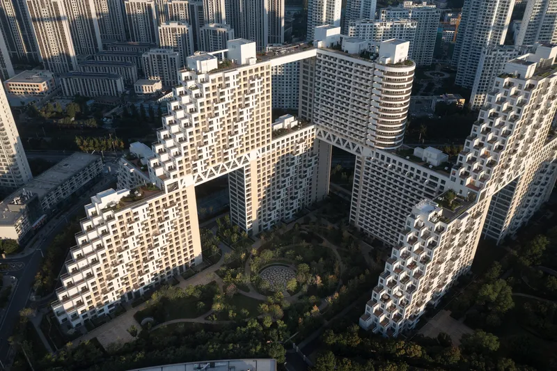 Aerial view of central courtyard enclosed by four towers with staggered balconies and landscaped ground plane