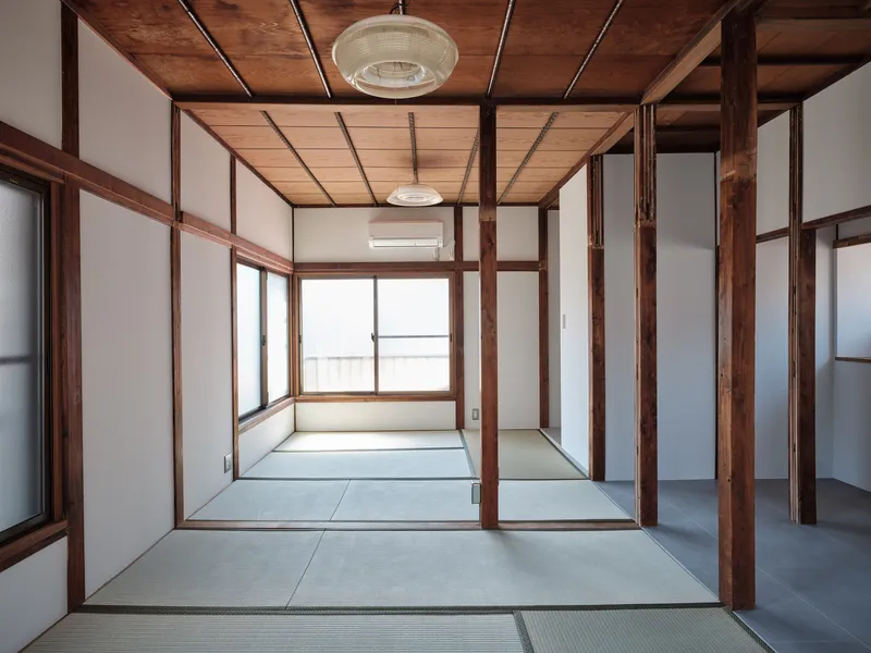 Tatami mat room with timber frame partitions and translucent sliding screens in soft daylight