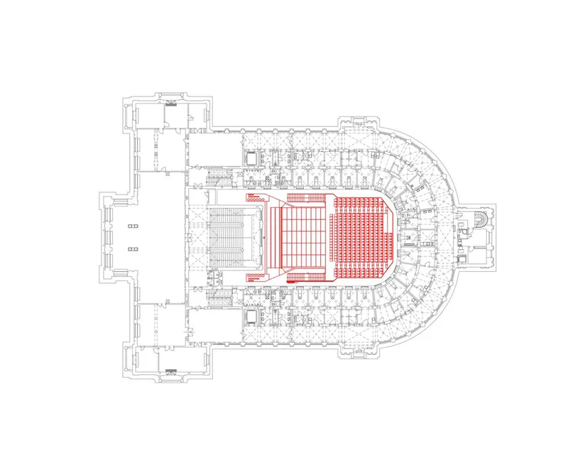 Floor plan drawing showing the auditorium seating arrangement highlighted in red within a curved perimeter