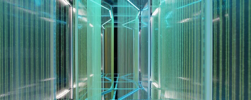 Interior perspective looking up at the structural steel frame suspended within turquoise and blue translucent panel walls