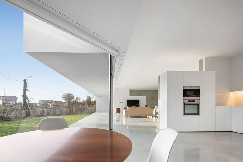 Open plan kitchen and living space with terrace access under angled ceiling soffit
