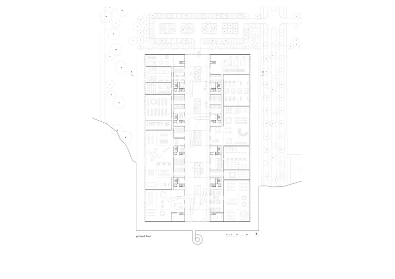 Ground floor plan drawing showing paired linear volumes with surrounding parking and landscaping