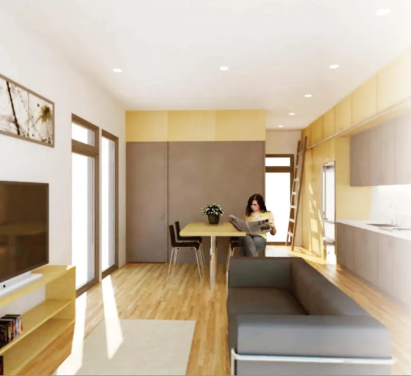 Interior living space with light wood flooring and a resident reading at the dining table
