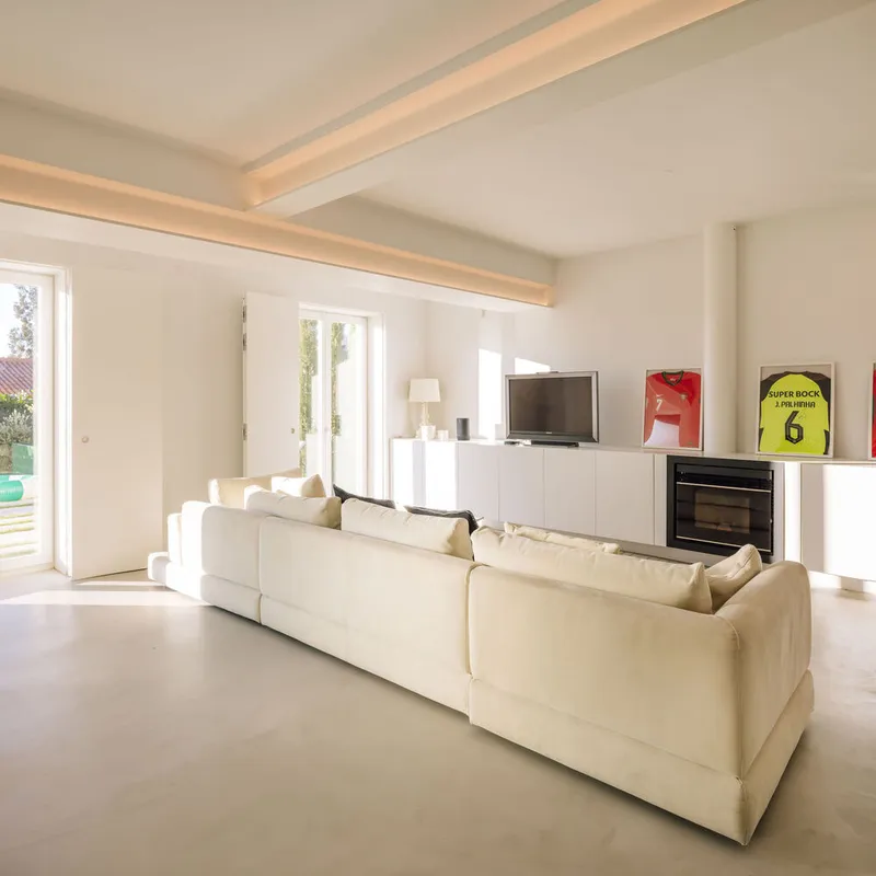 Living room with recessed ceiling beams and black fireplace unit integrated into media console