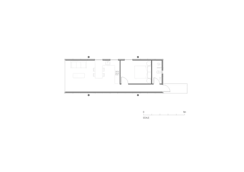 Floor plan drawing showing a linear layout with living area, bedroom, bathroom and small outdoor deck
