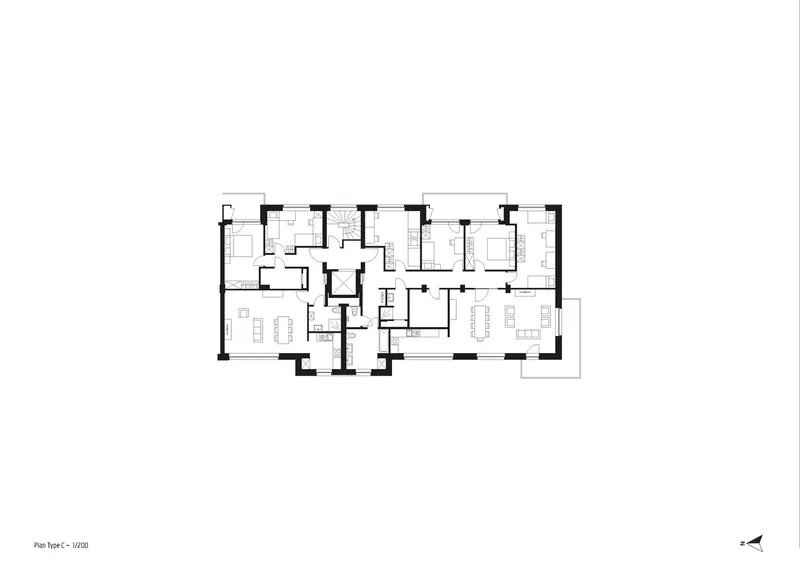 Floor plan drawing showing multiple residential units with living areas and bedrooms around a central core