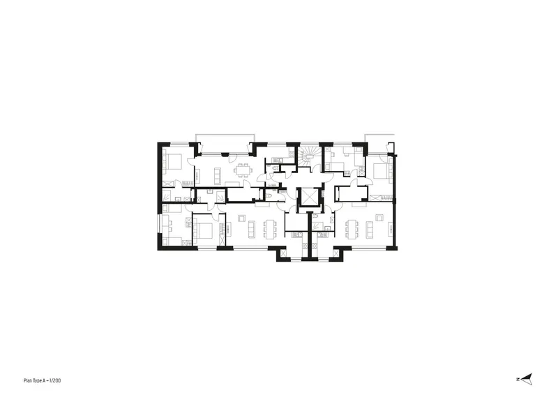 Floor plan drawing showing residential units arranged symmetrically around a central stair and elevator core