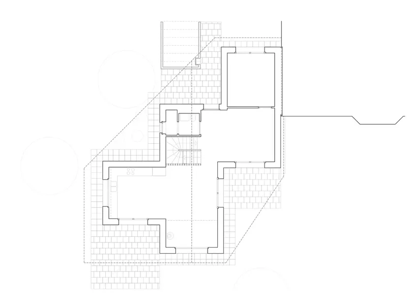 Floor plan drawing showing an L-shaped layout with grid hatching indicating exterior terraces