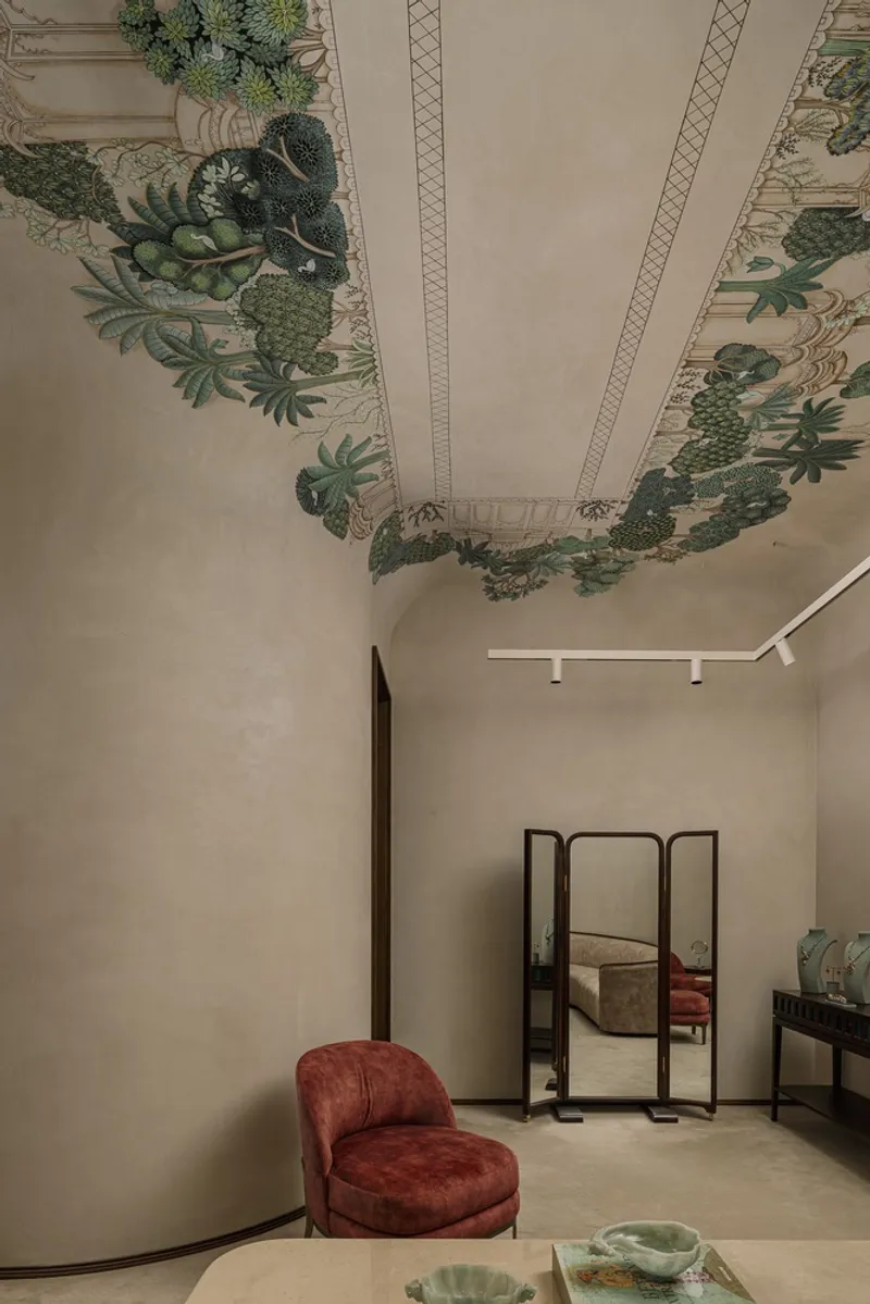 Interior room with painted ceiling border depicting tropical foliage and a freestanding mirror