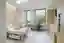 This architectural image showcases a modern hospital room designed for patient comfort and efficient