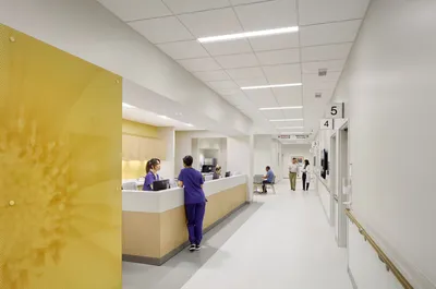 This architectural photograph showcases the interior of a modern hospital, featuring a clean and min
