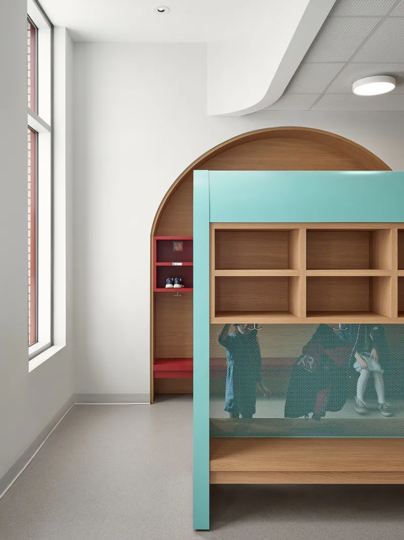 Wood-framed archway leading to storage cubbies with teal glass partitions under recessed ceiling lights
