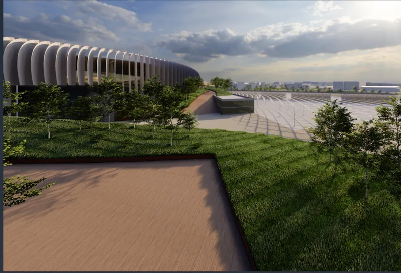 Landscaped plaza with sunken walkways and grassed berms surrounding the ribbed stadium volume in afternoon light