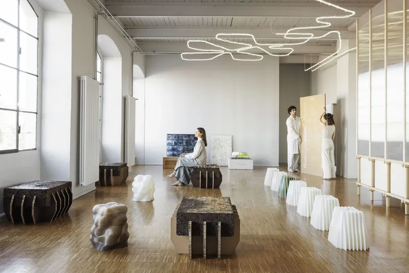 Open showroom with corrugated cardboard furniture and curving LED light installation overhead