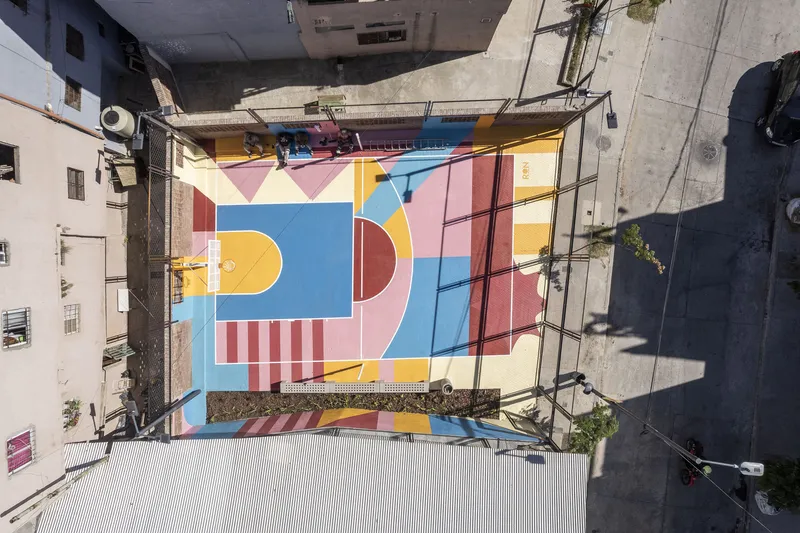 Overhead view of the painted basketball court surface showing geometric patterns and center circles