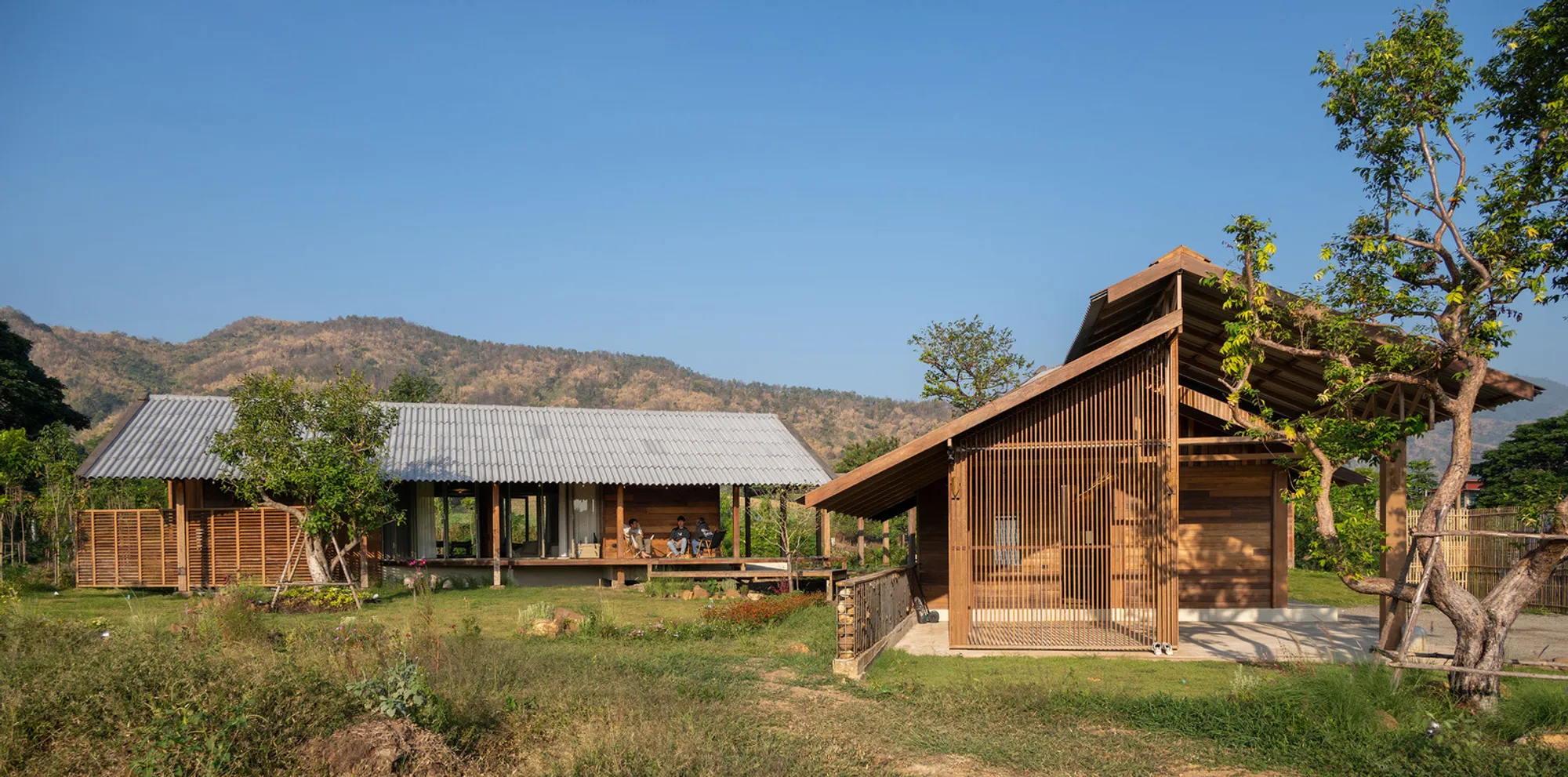 Housescape Design Lab Rebuilds Three Dismantled Houses into a Stone-Footed Compound in Phetchabun