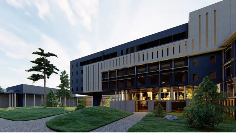 Main entrance with glazed lobby beneath a cantilevered upper volume and vertical timber screening at twilight