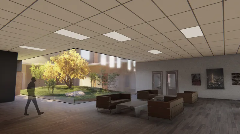 Interior lobby with drop ceiling and glazed courtyard featuring a tree and walking figure