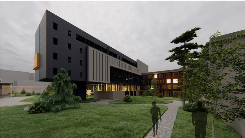 Multi-story facade with dark cladding and vertical timber screen beside a landscaped lawn at dusk