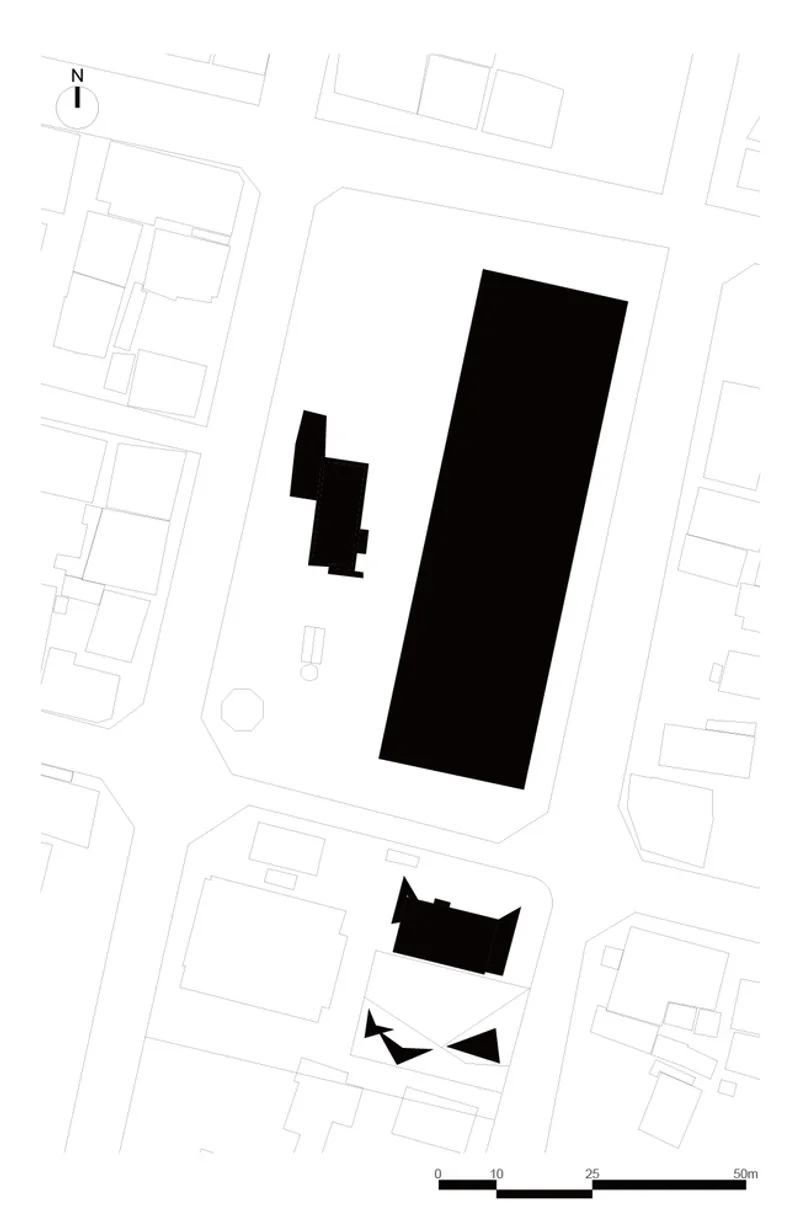 Site plan drawing showing building footprints in black within an urban block with surrounding streets and parcels