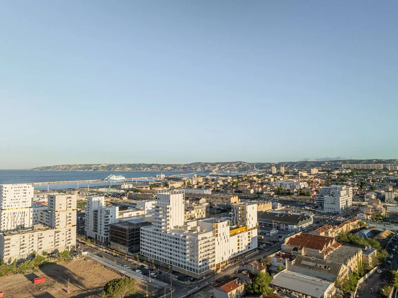 Elevated view showing the development cluster along the coastline at golden hour