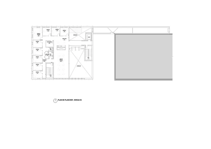 Floor plan drawing showing classroom spaces arranged along a corridor with a skylit central gathering area