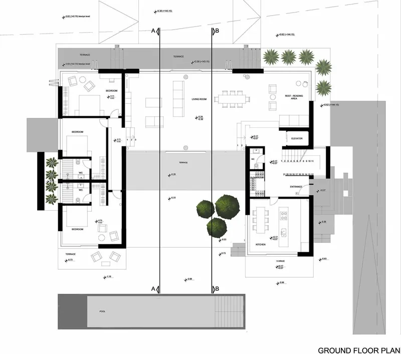 Ground floor plan drawing showing open living areas, kitchen, bedrooms, terraces, pool, and three mature trees in the courtyard
