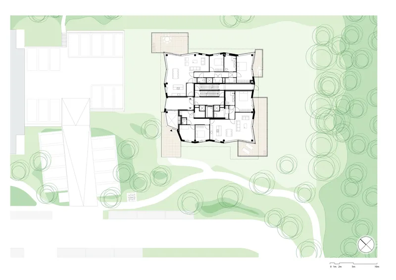 Site plan drawing showing a building footprint surrounded by circular tree canopies and landscape pathways