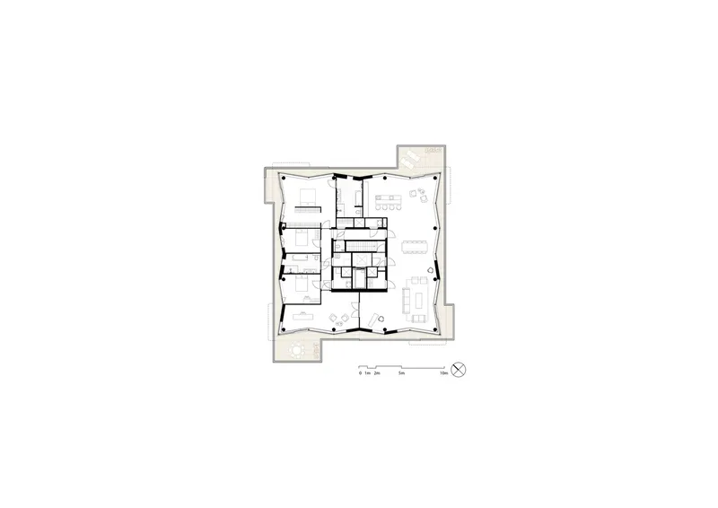 Floor plan drawing showing open living spaces and circulation around a central stair core