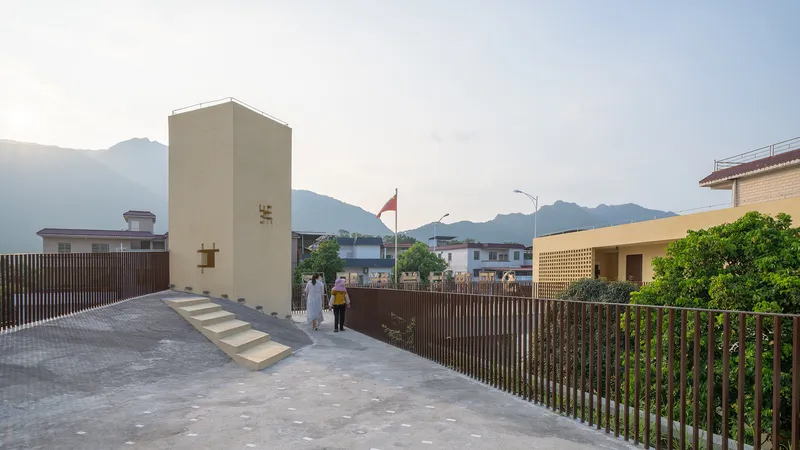 Rooftop terrace with vertical timber screening and concrete tower with mountains in the distance at dusk
