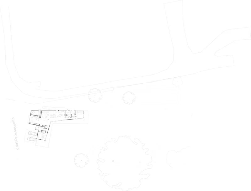Site plan drawing showing the angled building footprint with surrounding landscape contours and circular tree canopies