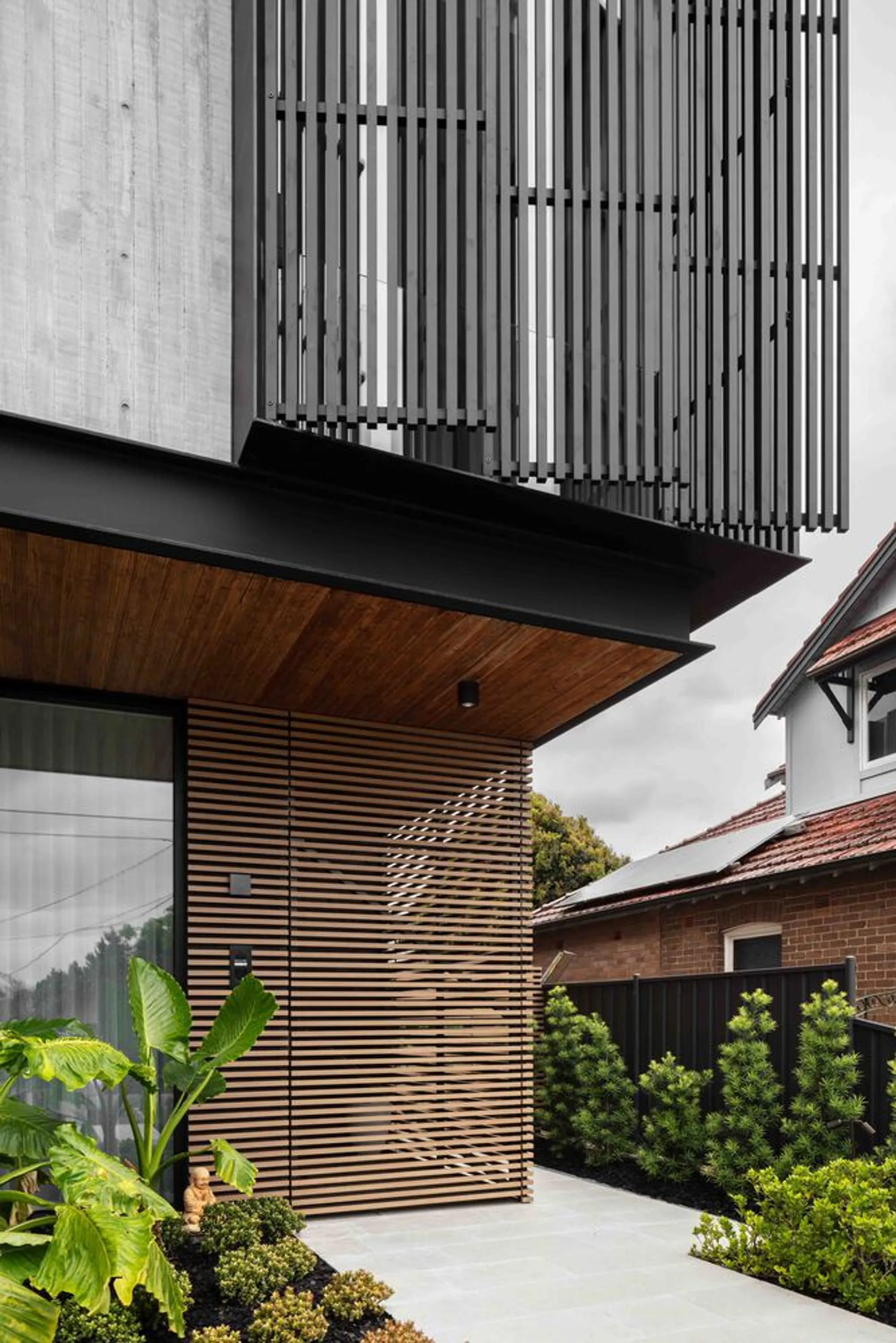 Studio Parisi Architects Wraps a Brutalist Suburban House in Timber, Concrete, and Green Defiance