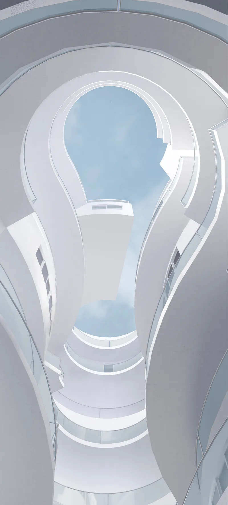 Looking up through the central atrium at the spiraling white floors and circular skylight