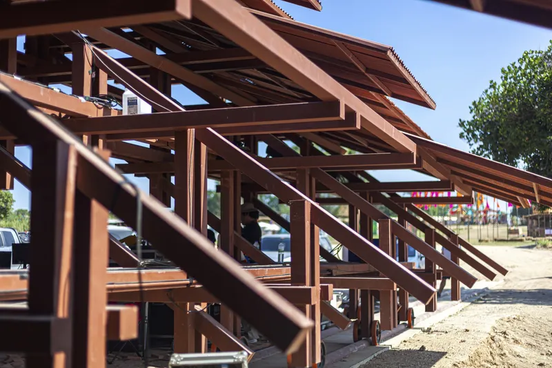 Close-up of the steel-braced timber structural system supporting the cantilevered roof edge