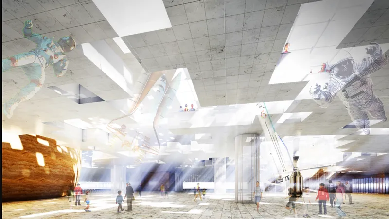 Interior gallery with concrete ceiling, skylights, hanging rocket and astronaut figures, and blurred visitors below