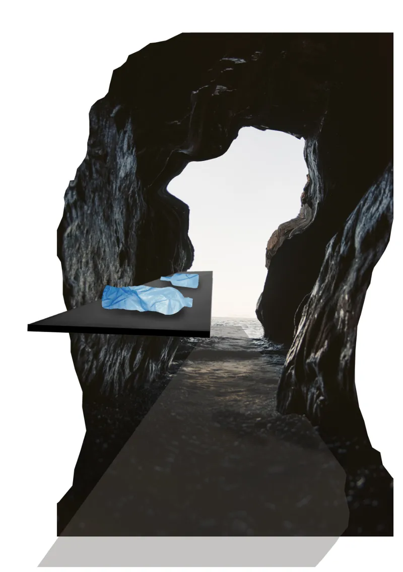 Black platform with blue draped fabric positioned within a narrow cave passage