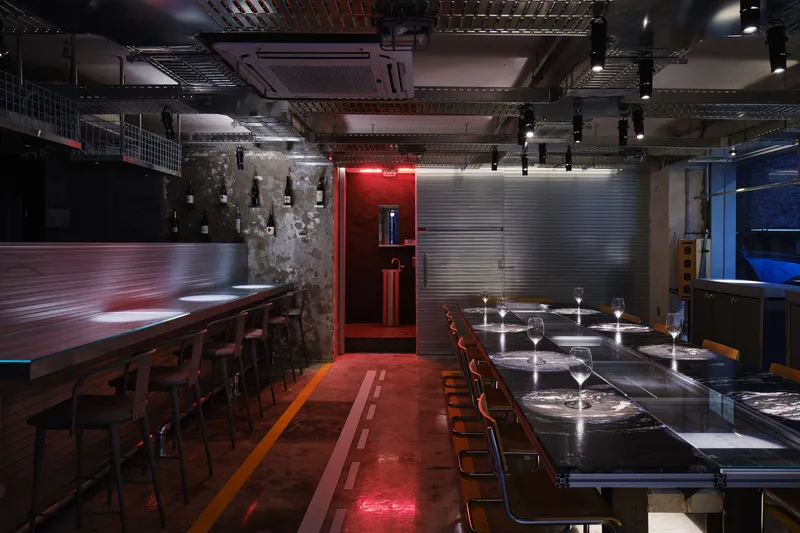 Evening view of the dining hall with red accent lighting from the restroom alcove