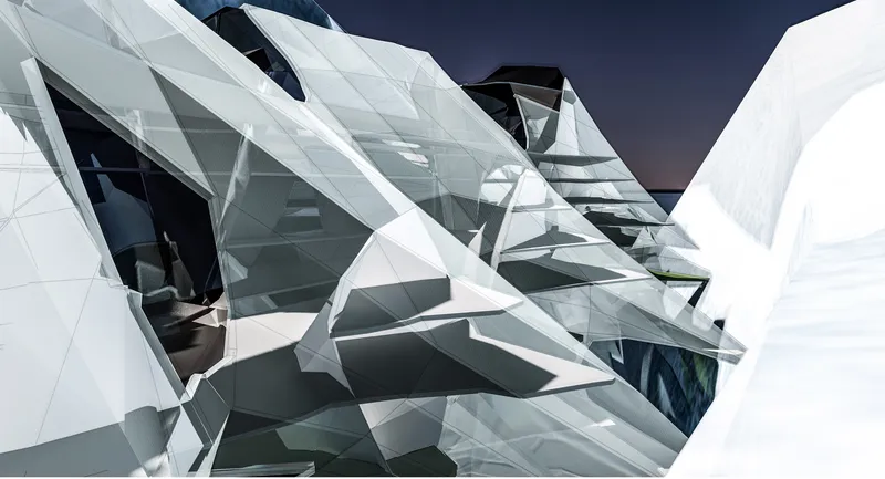 Close-up of intersecting white faceted panels and angular glazing meeting at multiple geometric joints