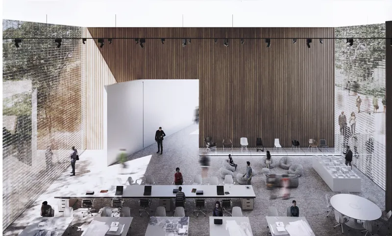 Overhead view of the double-height workspace with timber-clad walls and visitors moving through the ground floor