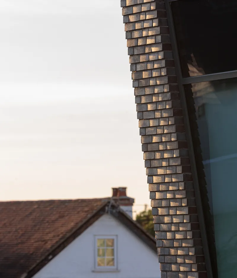 Close-up of corner brick detail with staggered projections at sunset