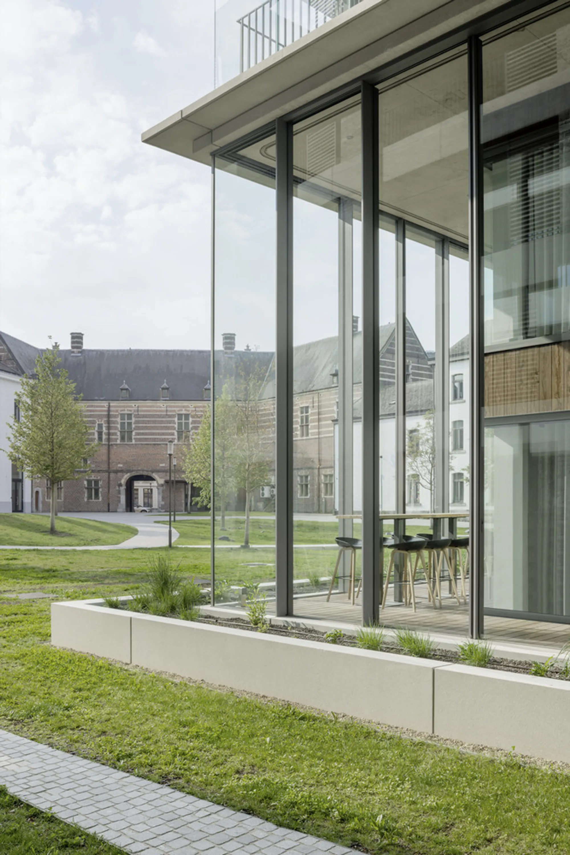 Four Studios Turn a Belgian Military Barracks into a Glass Tower Wrapped in Winter Gardens