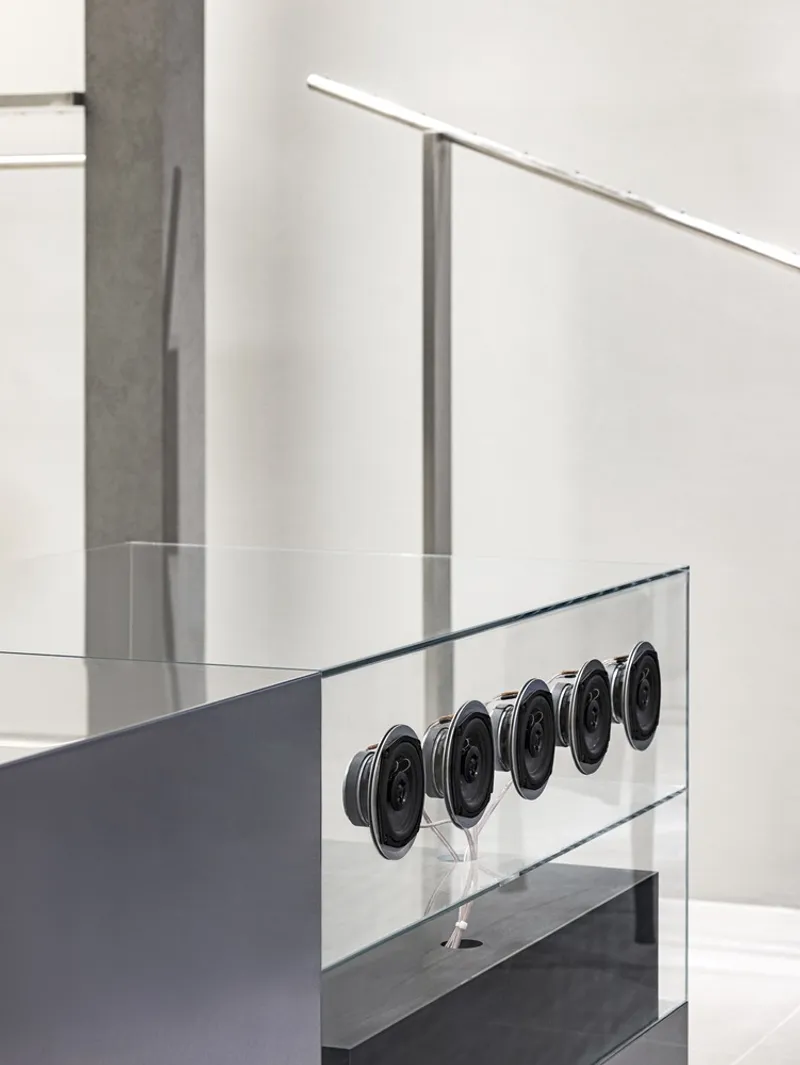 Detail of circular metal buttons embedded in a clear glass display case