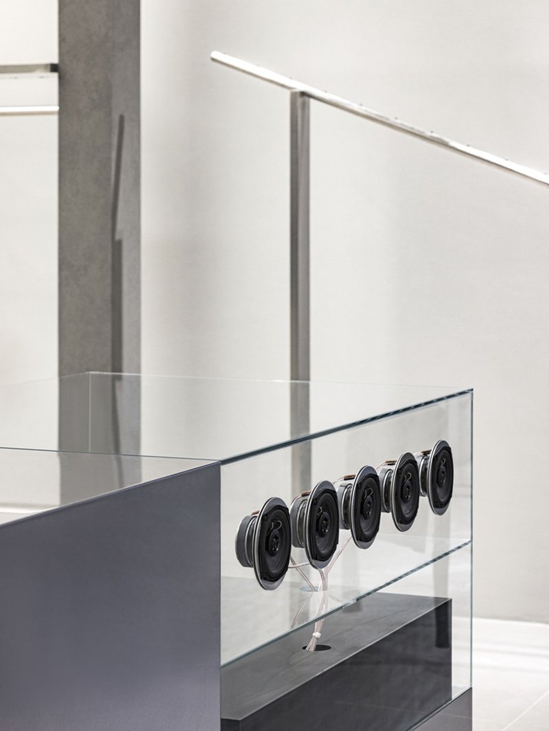 Detail of circular metal buttons embedded in a clear glass display case